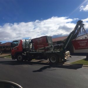 Driver Mick collecting a 2mtr builders waste bin from Glenmore Park