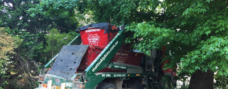 Skip bin delivery low hanging trees