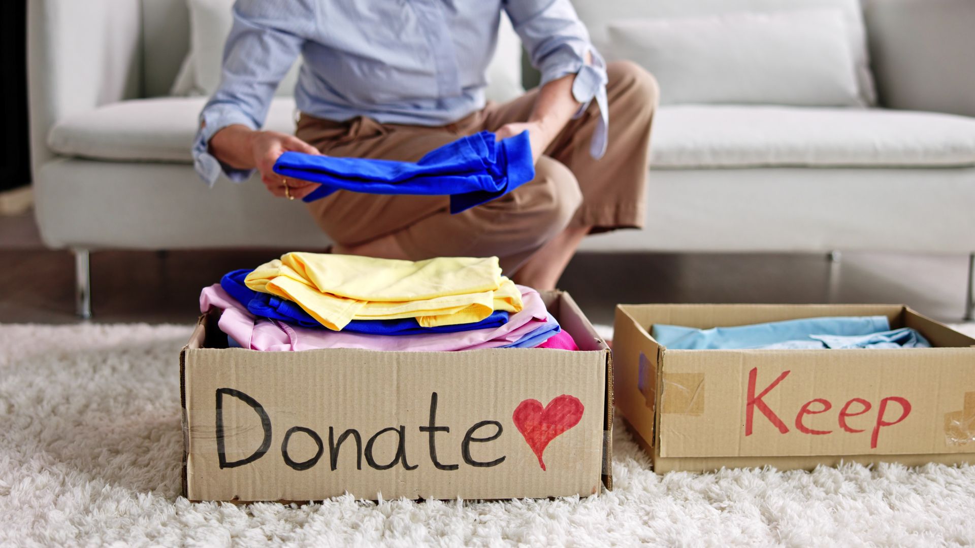 person sorting items into donate or keep